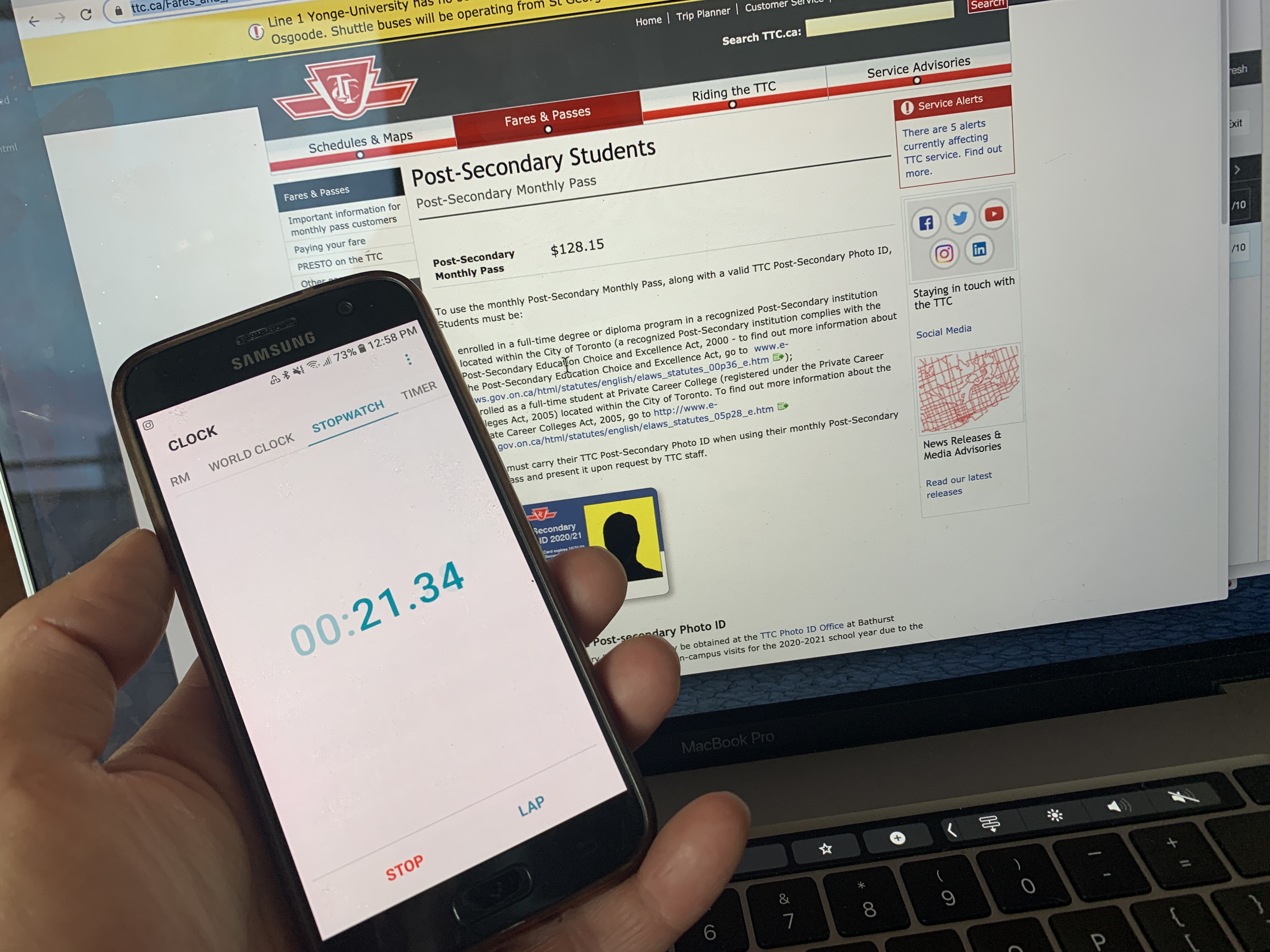 a laptop open to the TTC's Post Secondary Student Pass page, and a hand holding a cellphone with a timer that reads 21.34 seconds